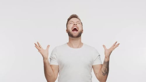 Expressive Young Man Screaming and Shouting Over Vibrant Background Portrait of Handsome Person