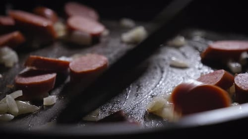 Frying Pieces of Sausage and Chopped Onions on a Frying Pan, Cooking Egg and Sausage Tortilla - Stea