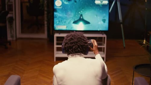 Gamer Shooting Foes Trying to Defeat Them in Classic Arcade Space Shooter Videogame on Smart TV