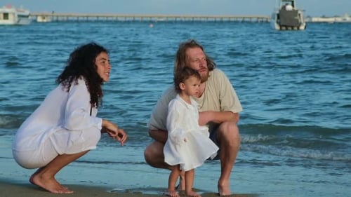 Mom with Dad and a Child Have Fun on Vacation By the Sea on a Sandy Beach Weekend Walks Near the