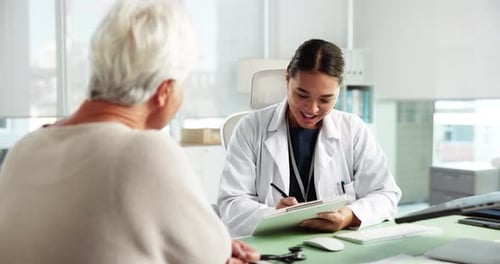 Doctor Consults with Elderly Female Patient in Office