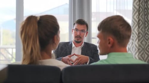 Couple Talking with Counselor in an Office Setting