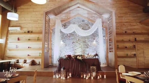 Wooden Banquet Hall with Decorations and Banquet Tables