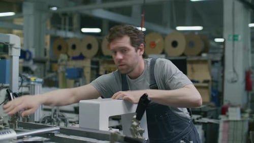 Technician Operating Industrial Machinery in Commercial Printing Factory