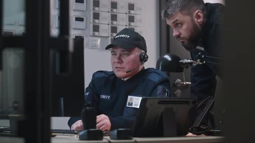 Security Guards Working in Modern Control Room