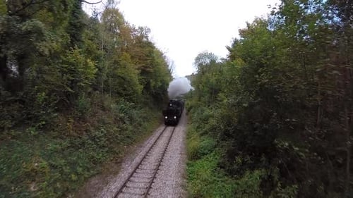 Historical Steam Engine Train Locomotive Driving on Railroad Tracks