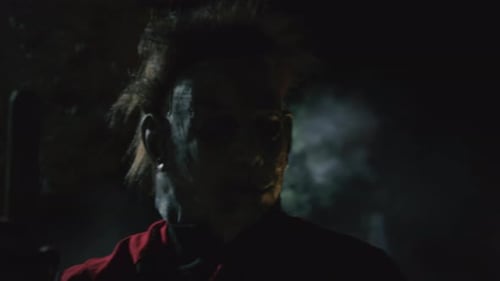Masked Figure with Baton at Night in Smoke