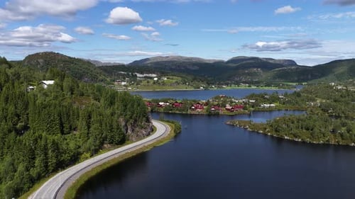 Aerial View of a Scenic Road Winding Along a Stunning Norwegian Fjord Lake