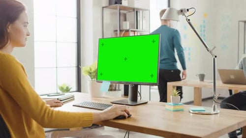 Woman Working at Computer with Chroma Key Screen