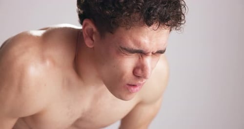 Tired, man and sweating in studio for workout break, endurance challenge and exercise fatigue