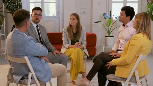 Group of business people having a meeting while sitting in circle in office.