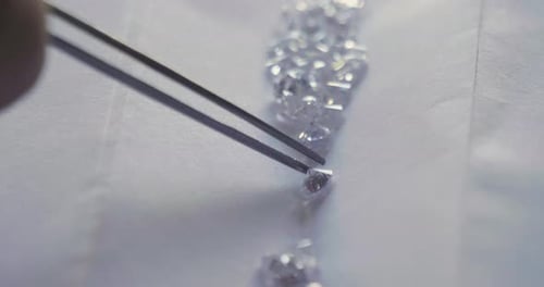 Close up of a goldsmith looking and showing a precious diamond. Concept: Gold, silver, jewelry