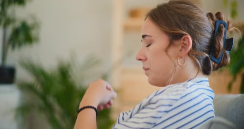Woman Holding Head Indoor from Headache Pain