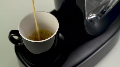 Coffee Pouring into a Mug from Espresso Machine