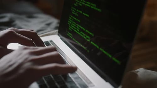 Close-up of Hands of Unrecognisable Male Programmer Coding on Laptop