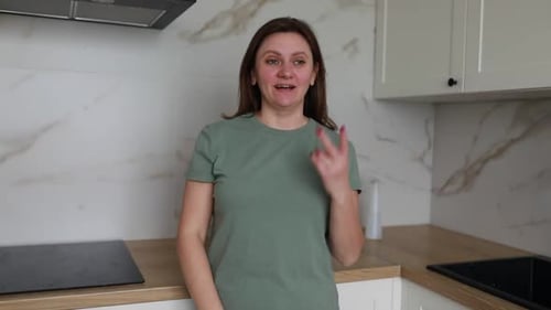 Auburn Haired Woman Talking in Kitchen