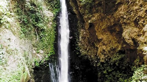 Drone flying up capturing a large waterfall