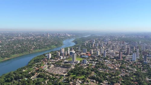 Aerial drone view of Foz do Iguacu cityscape with Parana River and Ciudad del Este in background.