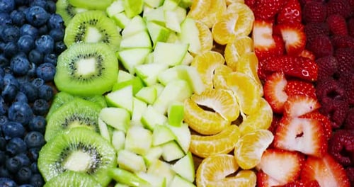 of fresh fruit mix composition, with strawberry, apple,blueberry,raspberry,kiwi, orange. Salad of