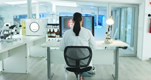 Scientist Working in Bright Laboratory on Virus Research