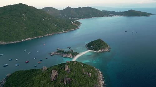 aerial establish of Nang Yuan Island, showcasing its turquoise waters and lush green hills against t