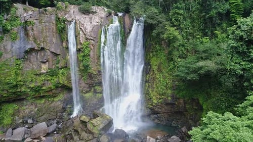 Breathtaking Aerial View of a Majestic Tropical Waterfall Hidden Deep