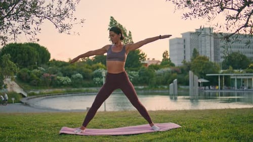 Sporty Woman Practicing Asana Raising Up Hand at Sunset Park Yoga Lady Training