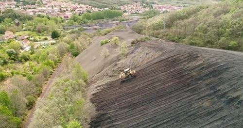 Bulldozer arbeitet an einem steilen Hang, Luftaufnahme