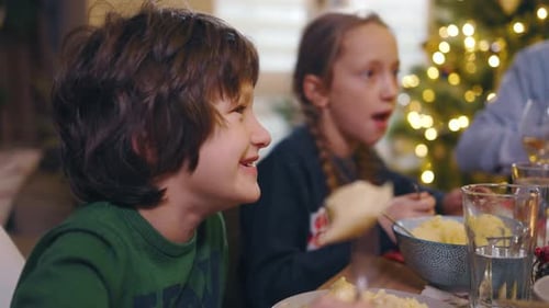 Children Enjoying Dinner Together During the Christmas Holiday