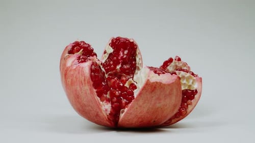 Uhd Vibrant Red Pomegranate On White Background