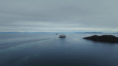 Aerial shot revealing ferries departing and arriving a port in Norway