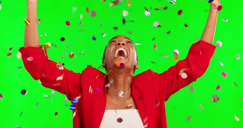 Black woman, celebration and dancing in confetti on green screen for winning