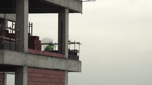 Construction Workers Laying Bricks on Building Site