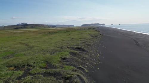 Breathtaking Aerial View of Dyrholaey Beach in Iceland With Black Sand Shores