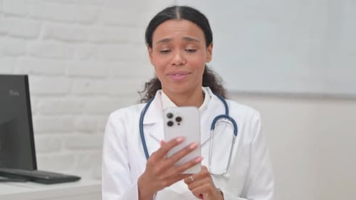 Female Doctor Holding a Phone Talking