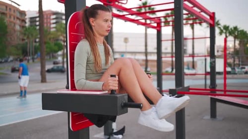 Woman Exercising on Machine in Urban Setting