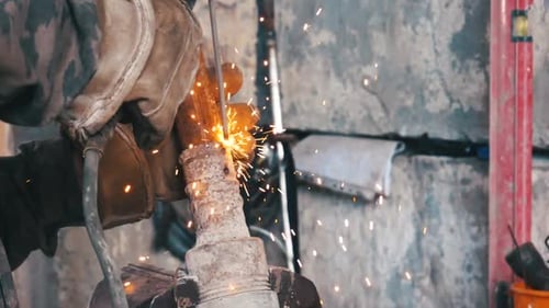 Close Up of Welder Sparks Flying in Workshop