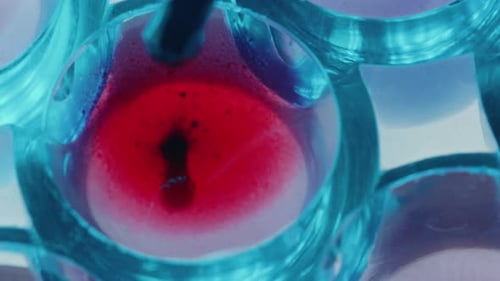 Pouring Blood into Liquid with Pipette during Laboratory Test