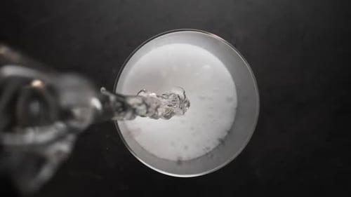 Champagne is Poured Into the Glass