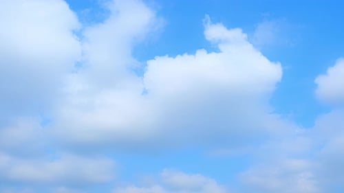 Clouds Drifting Across a Clear Blue Sky