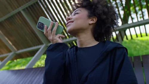 Woman Using Smartphone Voice Message Outdoors