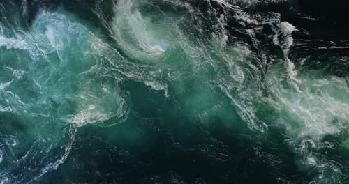 Blue waves of water of the river and the sea meet each other during high tide and low tide.