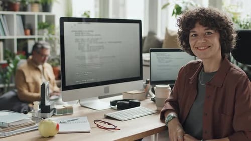 IT Specialist Sitting at her Workplace with Computer