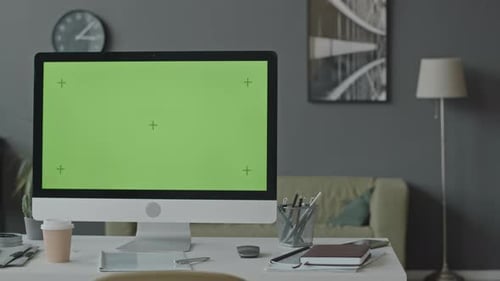 Computer Desktop with Green Screen in Modern Office