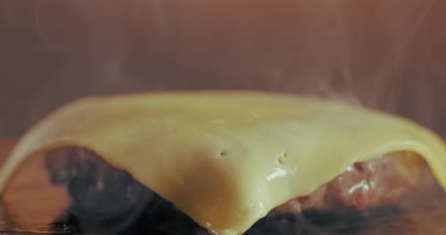 Smoke, meat and burger with cheese melt for restaurant cooking, fast food diner and lunch service