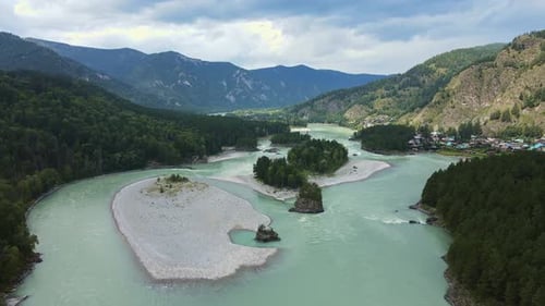 Aerial View of the Turquoise River Flowing in the Forested Mountain Valley
