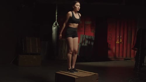 Active Motivated Sporty Fit Asian Female Doing Box Jump Exercise at Gym
