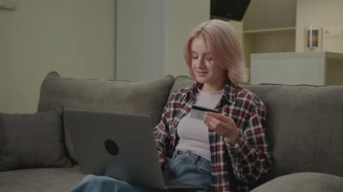 Woman Pays Online Using Laptop 20s Female Using Bank Credit Card for Online Shopping and Purchase