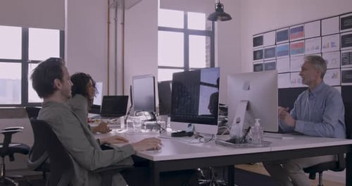 Team Discussing Data in Bright Modern Office