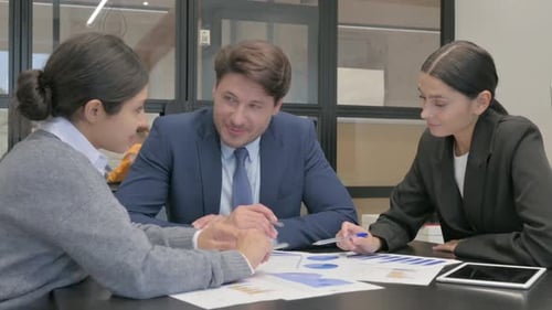 Business Colleagues Reviewing Charts and Graphs Together